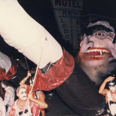Unknown people dressed up with a float in the parade.