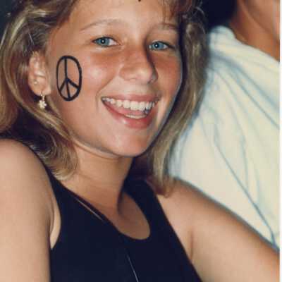 Unknown girl with a peace sign her face.
