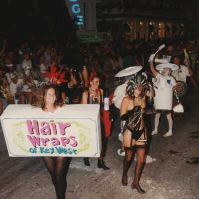Unknown people dressed up walking in the street for the parade.