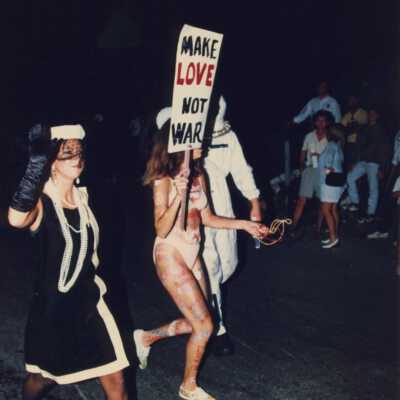 Unknown people walking down the street dressed up.