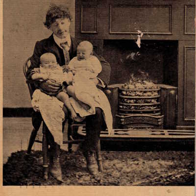 Man holding two babies