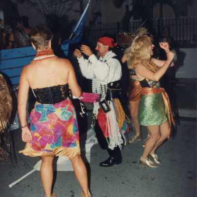 Unknown people dressed up near a float.