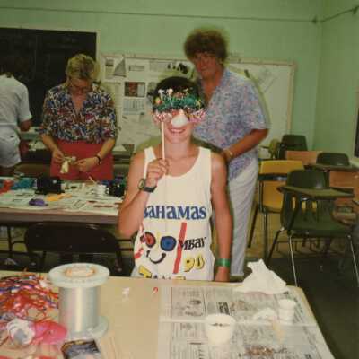 Unknown child holding a face mask to her face.