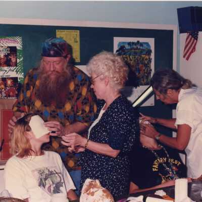 Unknown group of people making face mask.