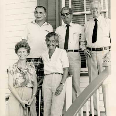 Unknown people standing outside of a house