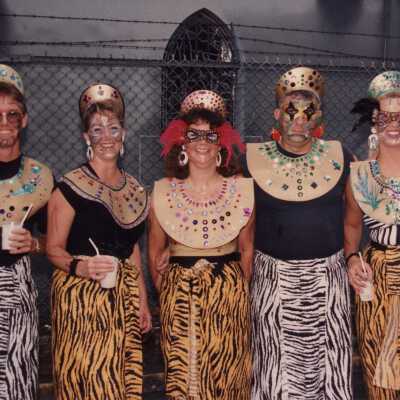 Unknown people standing by the cemetery dressed up.