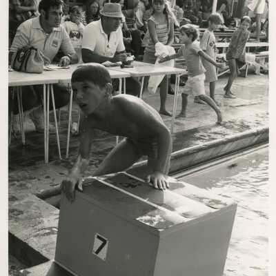 Unknown child at a pool with on lookers