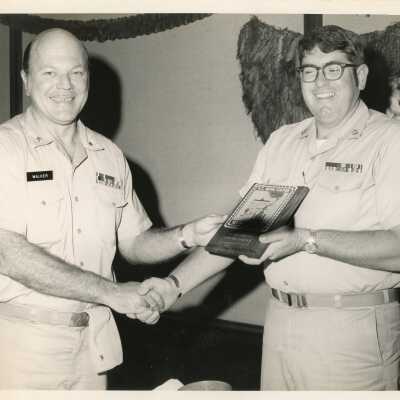 U.S. Navy man receiving a plaque