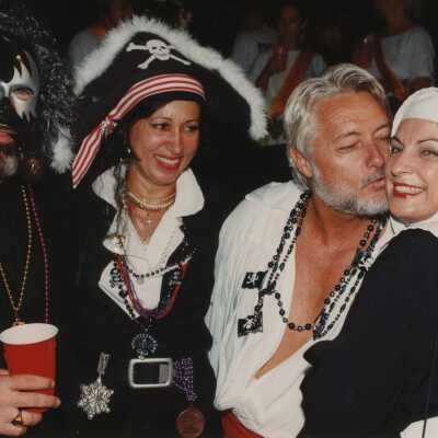 Four unknown people dressed up.