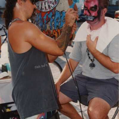 Unknown man getting his face painted.