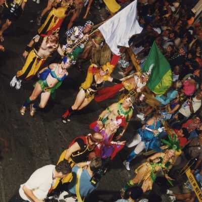 Unknown people dressed up walking in the street for the parade.