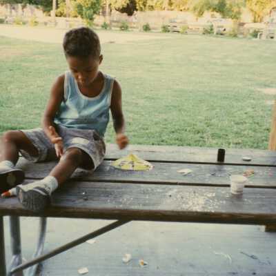 Unknown child playing on a table.