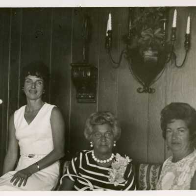 3 Unknown woman sitting in a living room