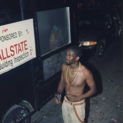 Unknown man walking next to a float.