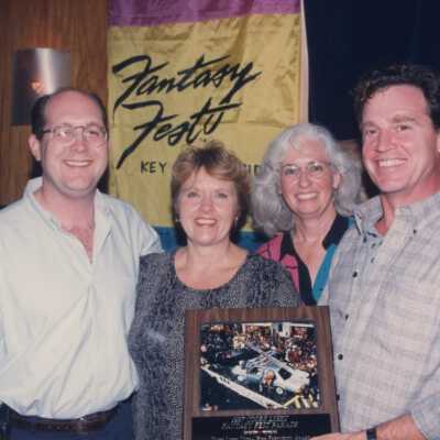 Unknown people accepting an award at the award ceremony.