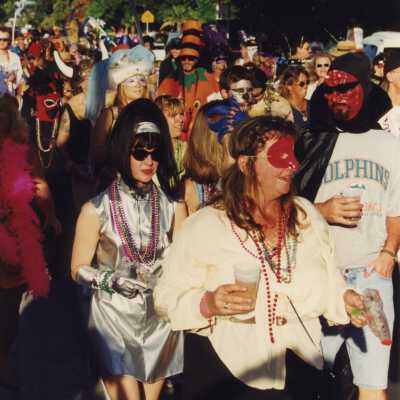 Unknown people dressed up walking in the street.