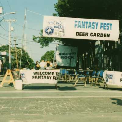 An area on the street set up with a banner that says FF beer garden.