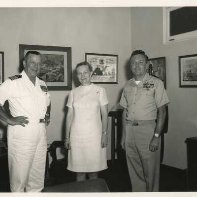 Unknown people standing in an office, 2 in uniform