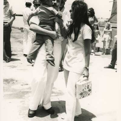 Unknown man in uniform with a woman and child