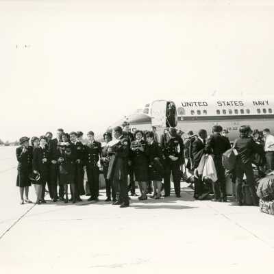 U.S. Navy men and woman with a plane