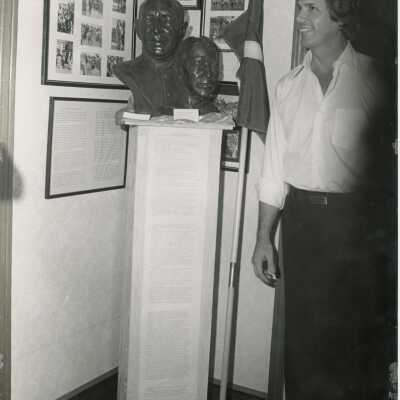 Unknown man standing next to a sculpture
