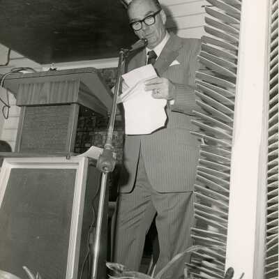 Unknown man speaking at the podium