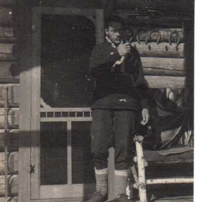 Unknown Man on Cabin Porch