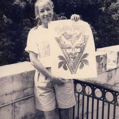 An unknown woman holding up a drawing that reads FF 92.
