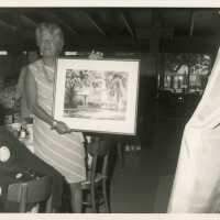 An unknown lady holding art work