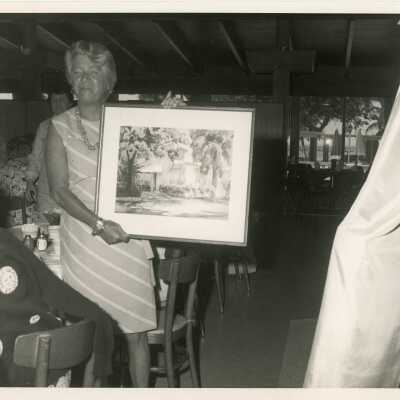 An unknown lady holding art work