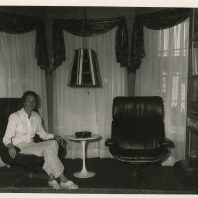 An unknown woman sitting in a living room