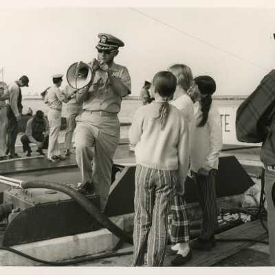 U.S. Navy ship with a few children on it