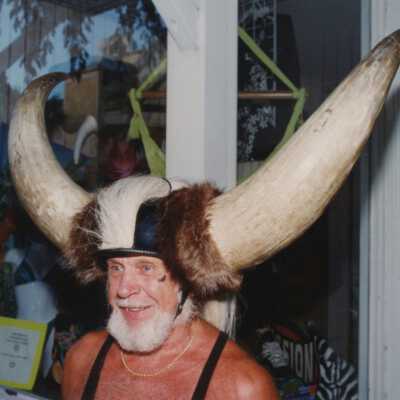 Unknown man dressed up with horns on his head.