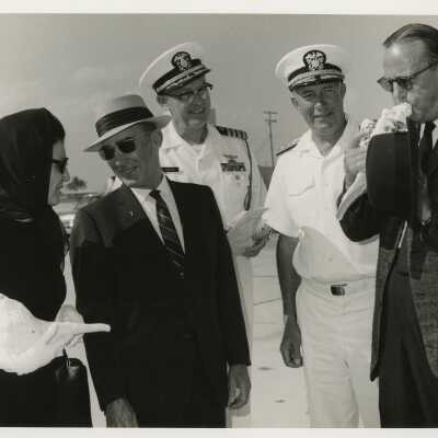 Unknown people standing around 2 with conch shells