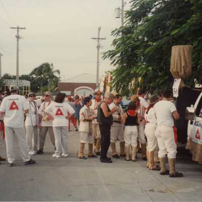 Unknown people standing around.