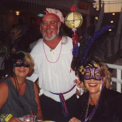 Three unknown people dressed up.