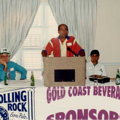 Unknown man talking behind a podium.