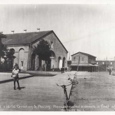 Child and bicycles in front of Building No. 1, Key West