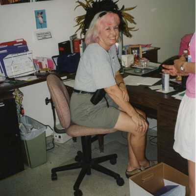 Unknown woman sitting at a desk.