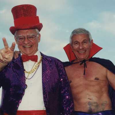 Two unknown men dressed up.