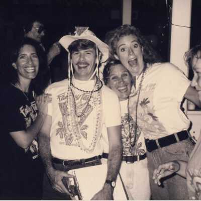 Unknown people standing around.