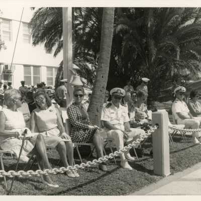 A group of unknown people sitting at a ceremony