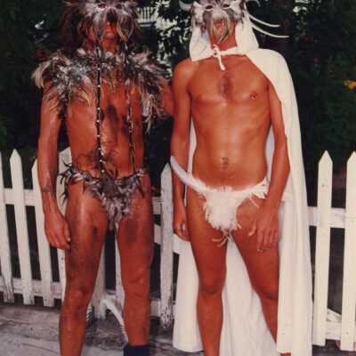 Two unknown men dressed up.