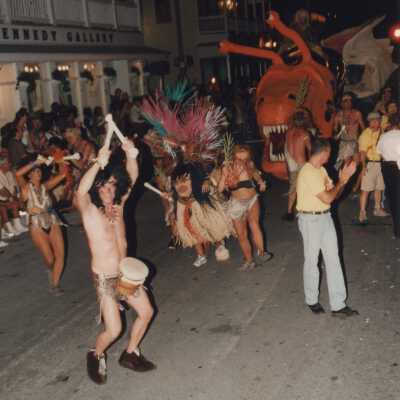 Unknown people dressed up walking in the street for the parade.