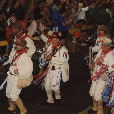 Unknown people dressed up in the street walking in the parade.