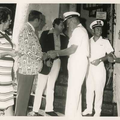 A few unknown men in uniform talking to a group of people