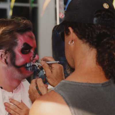 Unknown person having his face painted.