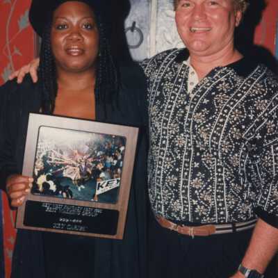 Unknown woman and man with a plaque.