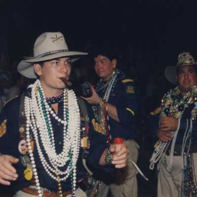 Unknown men dressed up with tons of beads.