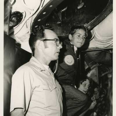 Unknown man and children in a U.S. Navy ship